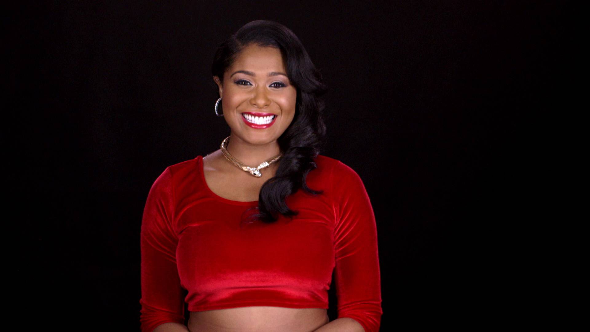Althea Heart in a red velvet top in a VH1 Check Yourself promotional still