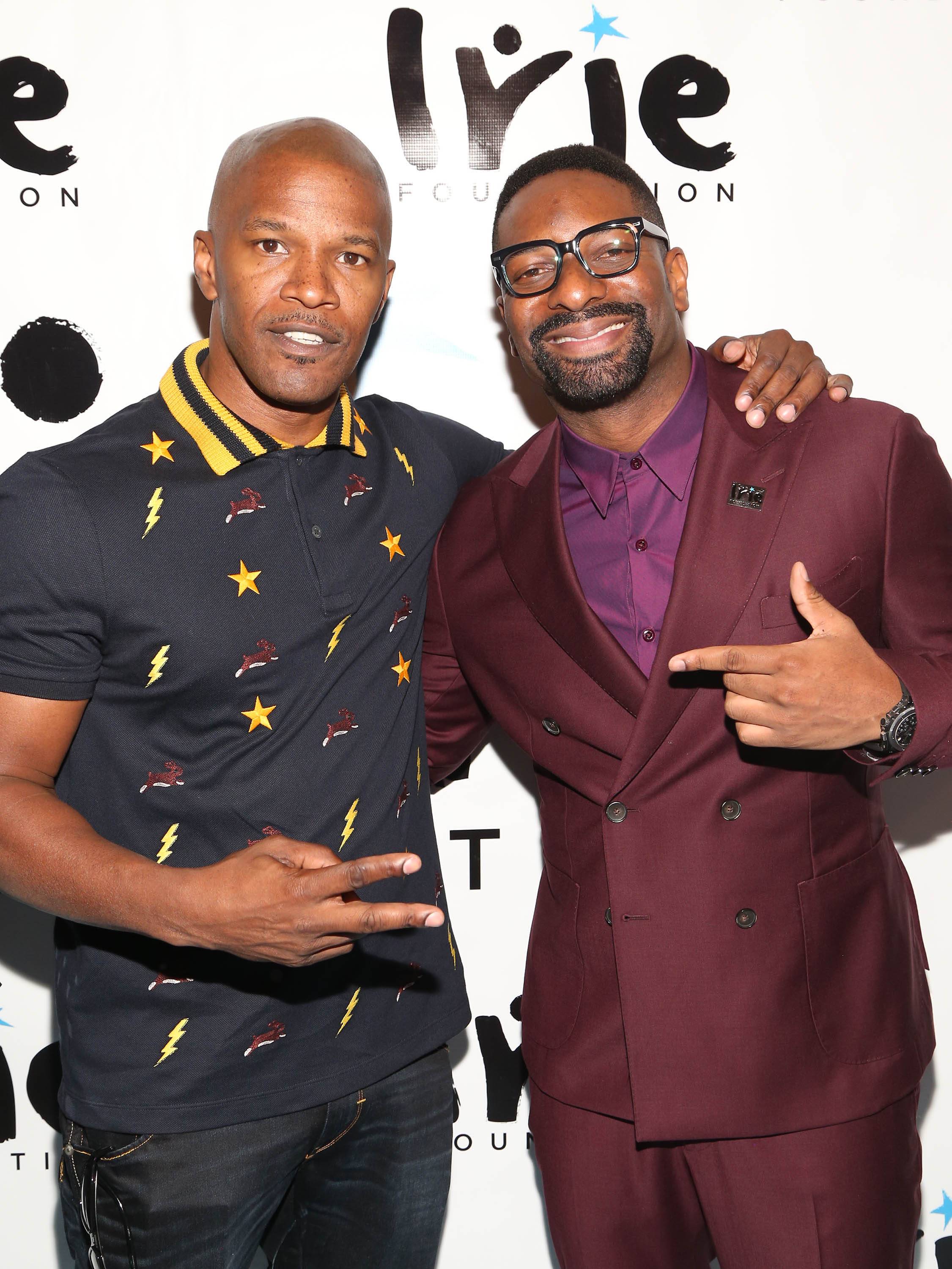 Pharrell Williams and Usher both wear color-coordinated outfits