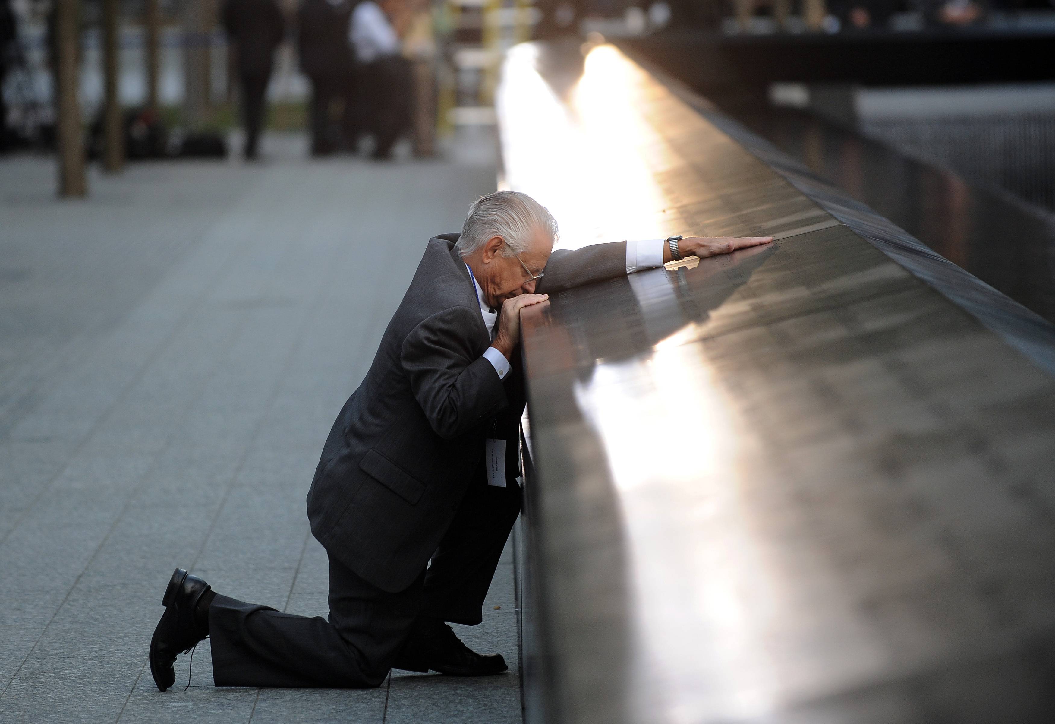 A Father Mourns - Robert Peraza, who lost his son Robert David Peraza in the attacks at the World Trade Center, pauses at his son's name at the north pool of the 9/11 Memorial.(Photo: AP Photo/Justin Lane, Pool)
