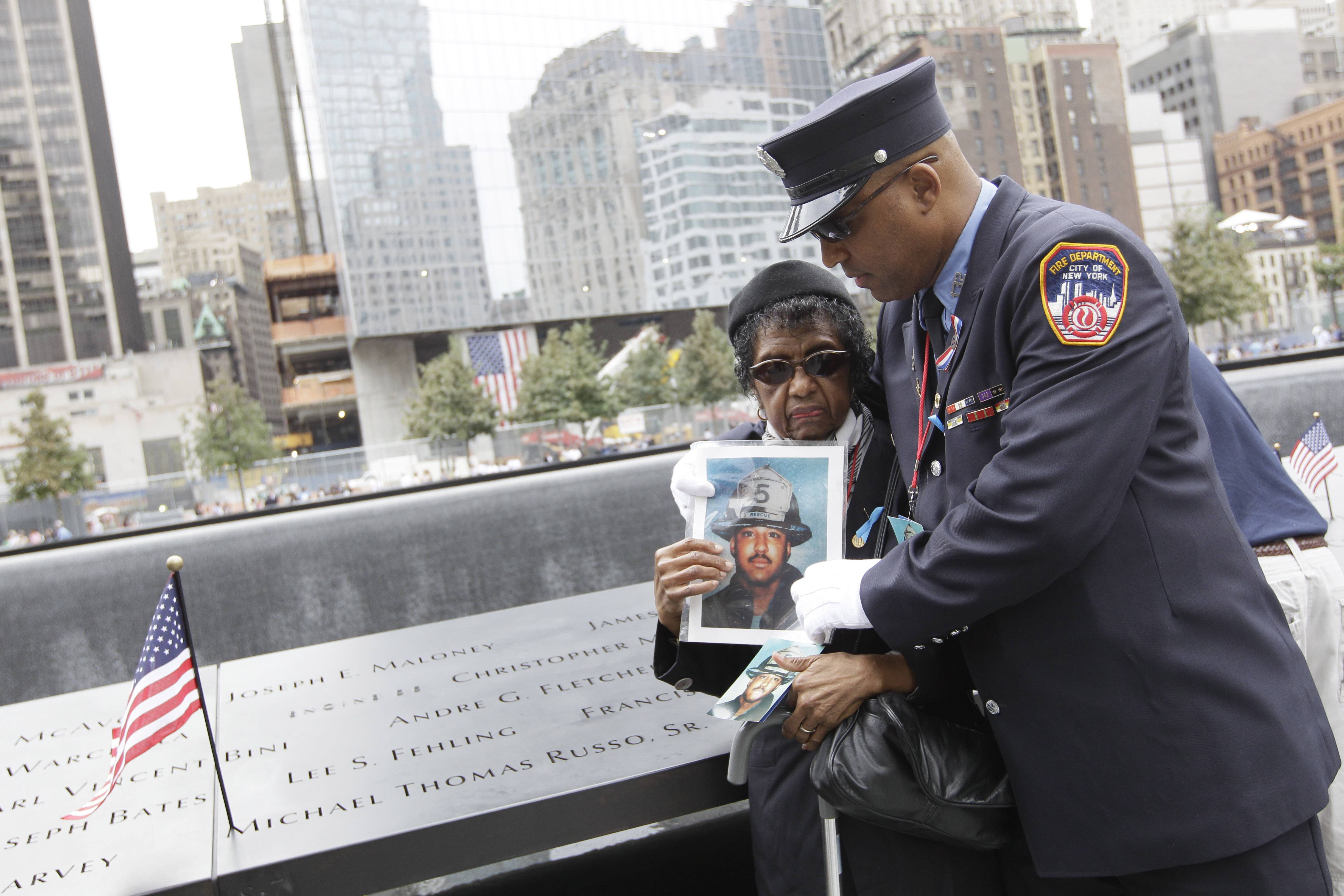 A Mother and Brother Mourn - New York firefighter Zachary Fletcher embraces his mother Monica Fletcher after finding his twin brother Andre G. Fletcher's name engraved at the south pool of the National September 11 Memorial.(Photo: AP Photo/Mary Altaffer)