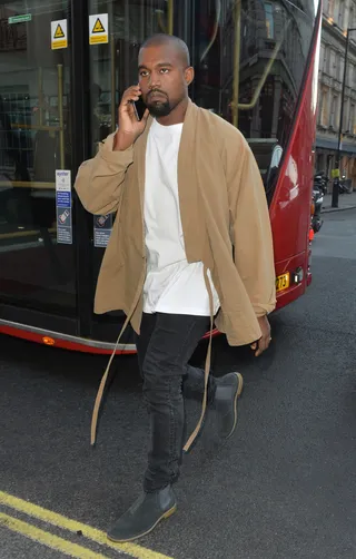 Man About Town - Kanye West talks on his cell as he walks to Haymarket Theatre in London.&nbsp;  (Photo: Palace Lee, PacificCoastNews)