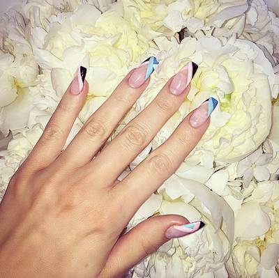 Khloe Kardashian - Koko makes her tips the star of the show here, decking them out in thick stripes of black, aqua and cobalt blue over a translucent pink base.(Photo: Khloe Kardashian via Instagram)