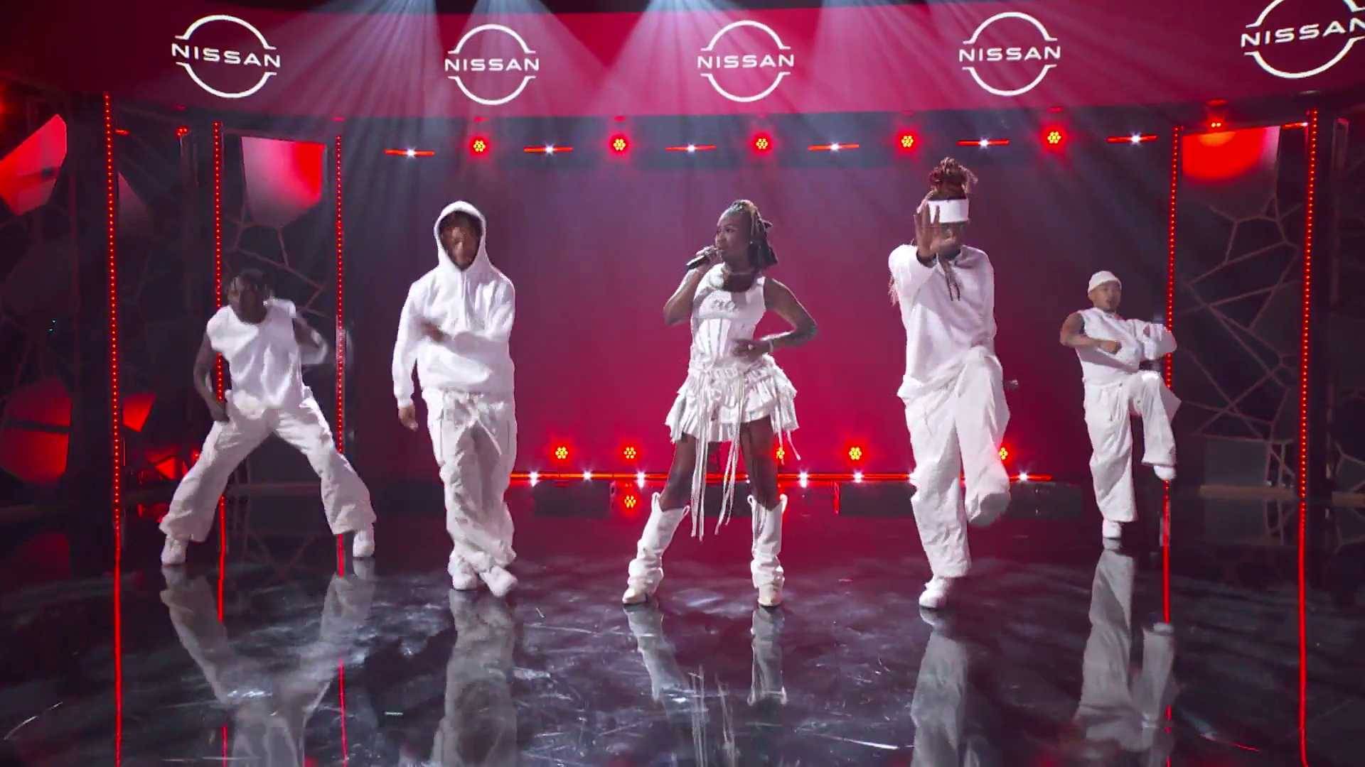 Kali takes the BET Amplified Stage in a white dress to perform her track "Area Codes" at the BET Awards 2023.