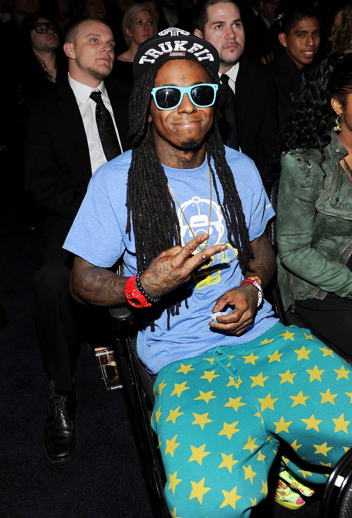 Quirk-star - Lil Wayne sports a colorful ensemble that looks almost like pajamas at the the 54th Annual Grammy Awards held at the Staples Center in Los Angeles. Though Weezy was nominated for three Grammy Awards, he went home empty-handed. (Photo: Larry Busacca/Getty Images)