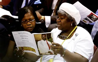 A Man Revered&nbsp; - Attendees read a program before the beginning of Sen.&nbsp;Clementa Pinckney's&nbsp;funeral service at the College of Charleston TD Arena. (Photo: Grace Beahm/Pool/Landov)