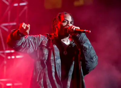 Travi$ Scott - Reportedly, Hustle Gang and G.O.O.D. Music affiliate&nbsp;Travi$ Scott let his iron fists fly after a fan tried to steal his chain off his neck during a Rodeo Tour stop in Arizona. Footage of a brawl surfaced online, showing the crowd jeering and the man identified as Scott eventually breaking away from the fight to return to the stage.(Photo: Dave Kotinsky/Getty Images)