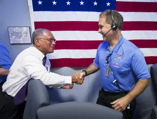Job Well Done - NASA Administrator Charles Bolden congratulates NASA Associate Administrator for the Science Mission Directorate John M. Grunsfeld after the successfull landing. The mission comes two years in the making and cost $2.5 billion. (Photo: Brian van der Brug-Pool/Getty Images)