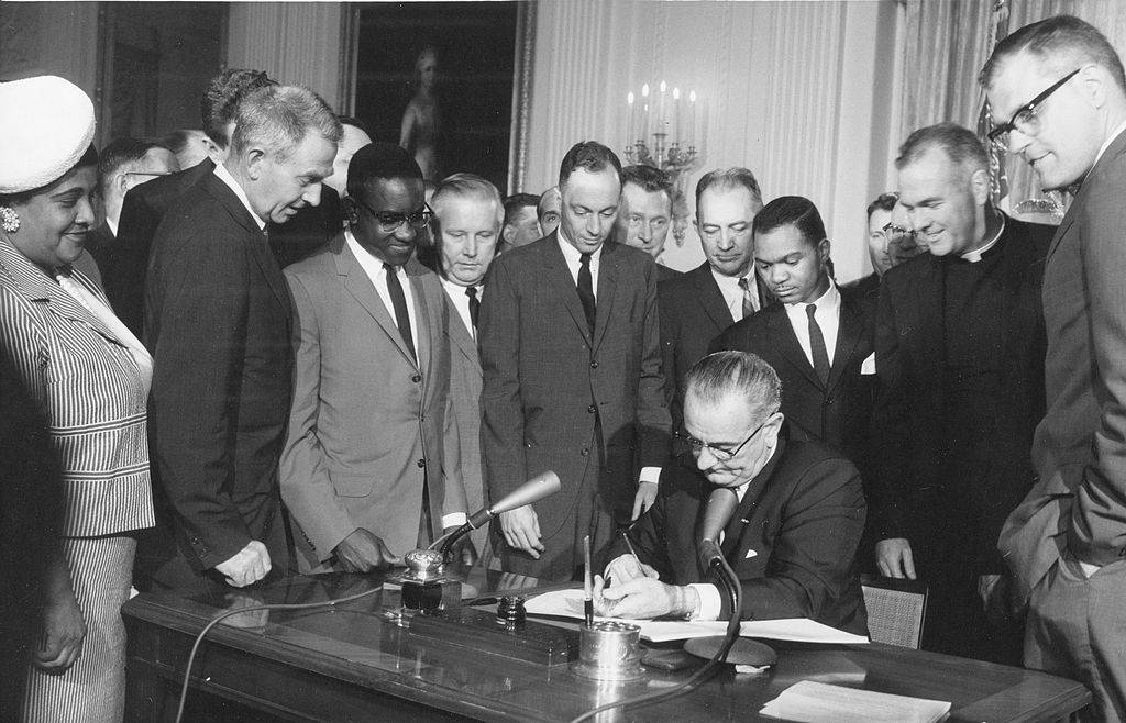 President Lyndon B Johnson signs the Civil Rights Act in a ceremony at the White House, Washington DC, July 2, 1964 . (Photo by PhotoQuest/Getty Images)