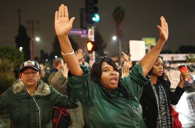 Hands Up, Don't Shoot - Protesters march in response to the decision by a New York grand jury not to indict a police officer involved in the chokehold death of Eric Garner on December 3, 2014, in Los Angeles. (Photo: David McNew/Getty Images)
