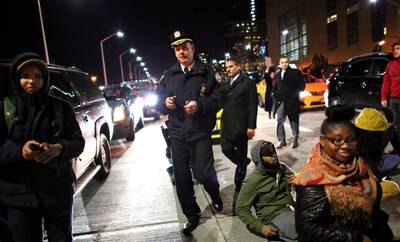 Marching on the Highway - Police walk through protesters on the West Side Highway December 3, 2014, in New York. (Photo by Yana Paskova/Getty Images)
