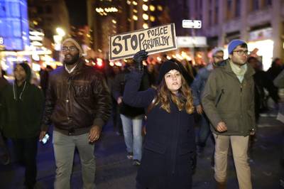 Stop Police Brutality - Protesters march through the streets in response to the grand jury's decision in the Eric Garner case in Times Square in New York.&nbsp;(Photo: AP Photo/Seth Wenig)