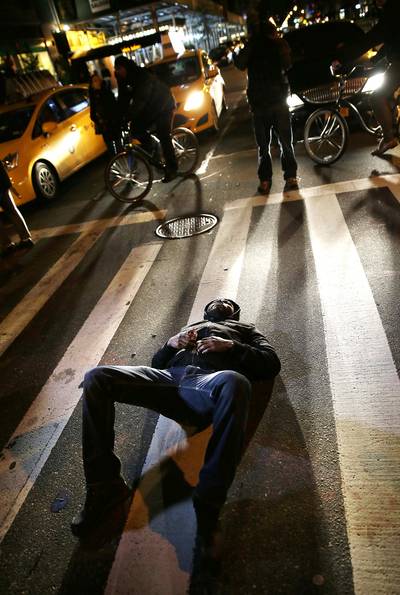 Laid Out for Justice - A protester blocks traffic in New York City.&nbsp;(Photo: AP Photo/Seth Wenig)