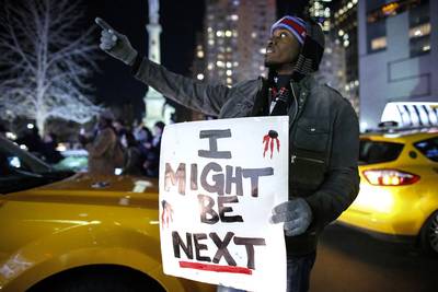 Am I Next? - A man holds a sign as he takes part in a protest on Sixth Avenue in Manhattan after a grand jury decided not to indict New York Police Officer Daniel Pantaleo in Eric Garner's death.&nbsp;(Photo: Kena Betancur/Getty Images)