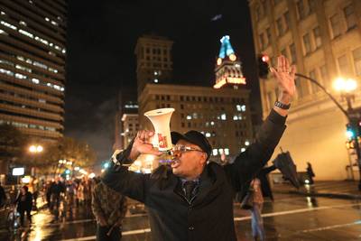 Oakland Stands Up - David Scott of Oakland leads a chant while marching down Broadway in Oakland, California. &nbsp;(Photo: Elijah Nouvelage/Getty Images)