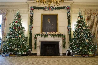 State Dining Room - The State Dining Room trees stand 14-feet tall and are decorated with vintage Union Pacific toy train pieces. Volunteers made the ornaments on the mantel that resemble Scrabble pieces that spell out &quot;winter wonderland.&quot;   (Photo: AP Photo/Evan Vucci)