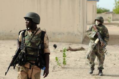 Boko Haram Suspected of Young Girl Suicide Bombing - Boko Haram is suspected of being behind a recent suicide bombing done by a young girl. &quot;The girl was about 10 years old and I doubt if she actually knew what was strapped to her body,” a civilian vigilante told AFP. The explosion occurred on the afternoon of Jan. 12, 2015, at a packed market in the Borno State capital, Maiduguri. A second explosion rocked the northeast region hours later, when a car bomb was detonated at a police station in neighboring Yobe. The driver and the police officer accompanying the car were killed.(Nigerian soldiers patrol in the north of Borno, a state close to one of Islamist extremist group Boko Haram’s former camps on June 5, 2013, near Maiduguri. Photo: Quentin Leboucher/AFP/Getty Images)
