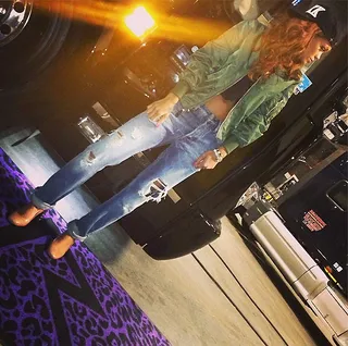 Rihanna @badgalriri - On a break from her Diamonds tour Rihanna poses for a flick in front of her tour bus. Check out her custom purple rug! (Photo: Rihanna via Instagram)