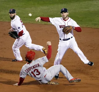 Double Play - Boston Red Sox Stephen Drew throws the ball over St. Louis Cardinals Matt Carpenter in the third inning to turn a double play to end his opponents’ chances of leading over Boston.&nbsp;(Photo: AP Photo/Chris Carlson)