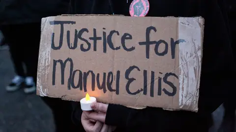 TACOMA, WA - JUNE 03: A person holds a sign during a vigil for Manuel Ellis, a black man whose March death while in Tacoma Police custody was recently found to be a homicide, according to the Pierce County Medical Examiners Office, near the site of his death on June 3, 2020 in Tacoma, Washington. Protests and other events sparked by the death of George Floyd have continued in the Tacoma area after the Medical Examiner found that the cause of death in the Manuel Ellis case was caused by respiratory arrest due to hypoxia due to physical restraint. (Photo by David Ryder/Getty Images)