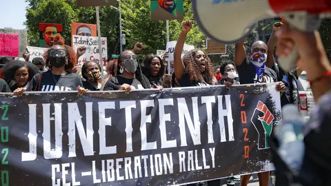 FILE- In this June 19, 2020 file photo, protesters chant as they march after a Juneteenth rally at the Brooklyn Museum, Friday, June 19, 2020, in the Brooklyn borough of New York. On Thursday, July 23, 2020, New York State passed a bill to designate June 19 as Juneteenth to commemorate the emancipation of slaves in the U.S. (AP Photo/John Minchillo, File)