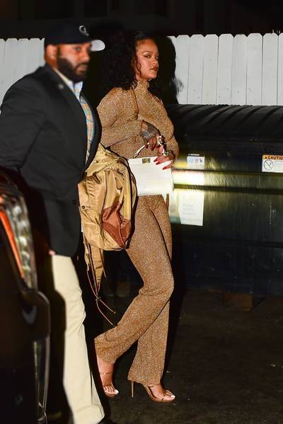 Golden Goddess - Rihanna stepped out for dinner in Santa Monica wearing matching gold sheer top ($470) and pants ($420) by Acne studios.&nbsp; (Photo: Backgrid)