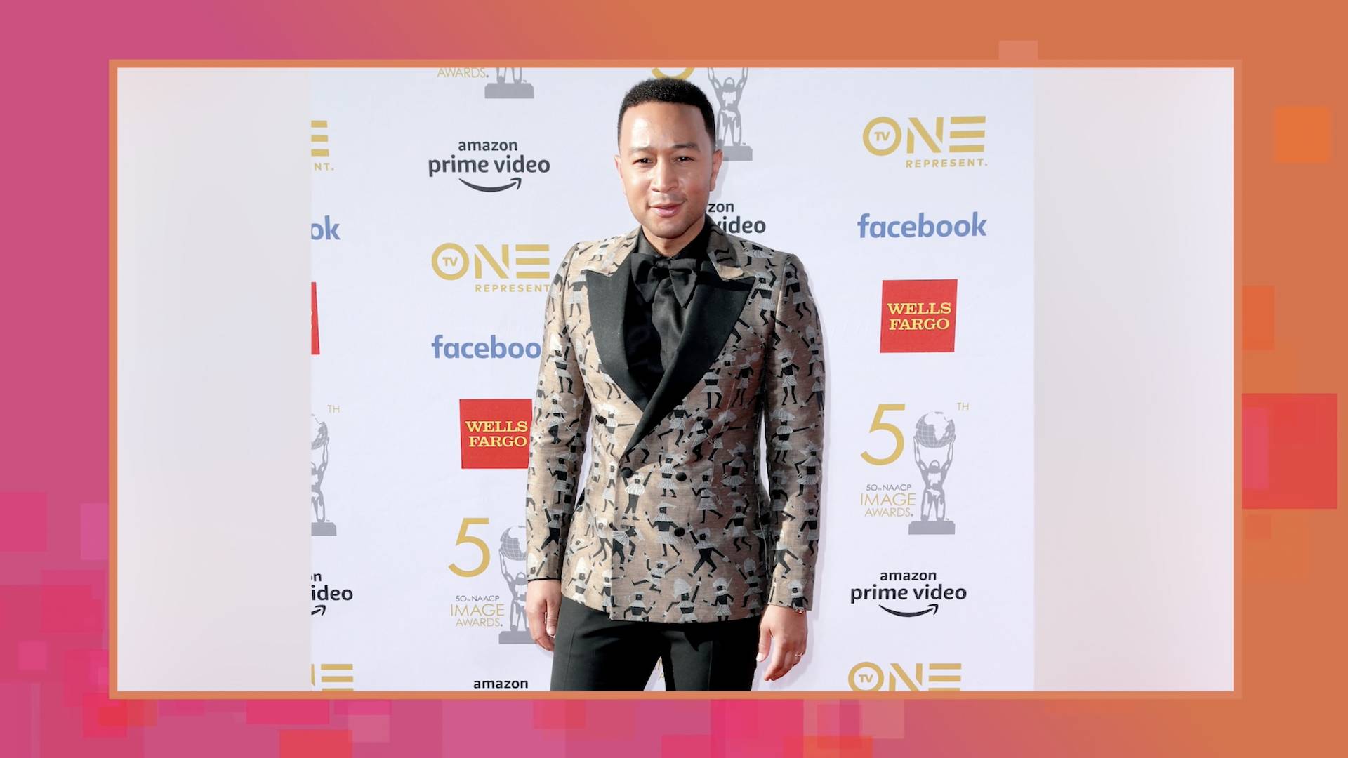 John Legend pictured on the 54th NAACP Image Awards red carpet, in a black and gold suit.