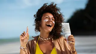 Woman at the beach with sunscreen on her face.