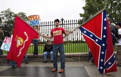 No Respect - Michael Ashmore of Hooks, Texas, protests the government shutdown in front of the White House holding the Marine Corps flag in one hand and a Confederate flag in the other.   (Photo: REUTERS/Joshua Roberts)