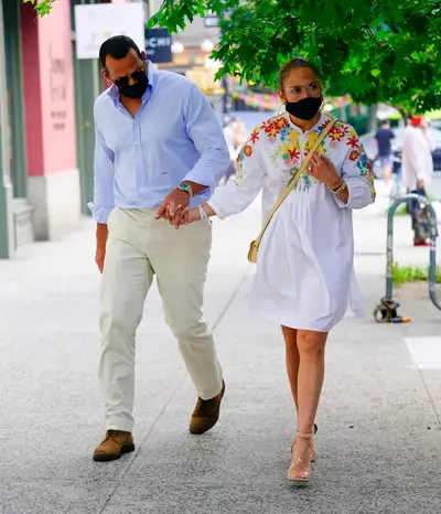 Date Night In NYC! - Jennifer Lopez and her fiancé Alex Ridriguez were spotted heading to dinner in NYC over the weekend. JLo stepped out wearing a white and floral dress by Valentino ($5,400), with nude sandles and a pair of Chanel sunglasses. The lovely couple even made sure to keep their masks on!&nbsp; (Photo: Getty Images)