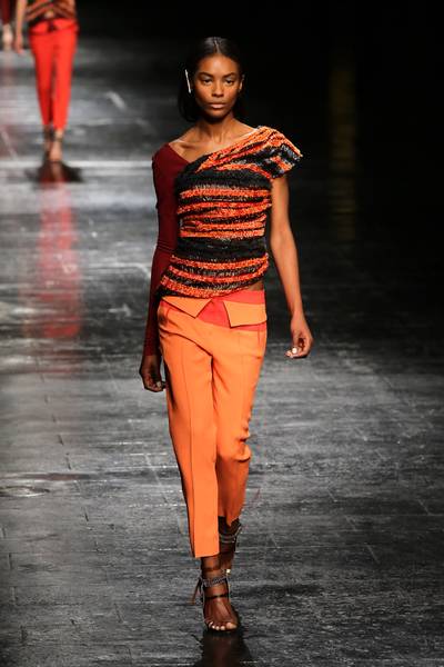 Prabal Gurung - Capturing the warm colors of fall, we’re loving the edgy design of this off-the-shoulder top and colorblock trousers.(Photo: Neilson Barnard/Getty Images)