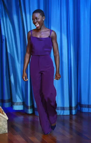 Lupita Nyong’o - Don’t be afraid to go monochromatic. It always looks chic and easily transitions from day-to-night. Try thinking outside the box by going for a rich jewel hue like Lupita’s eggplant top and trousers. We love adding a bib necklace and simple studs for a little shine.  (Photo: Theo Wargo/Getty Images)
