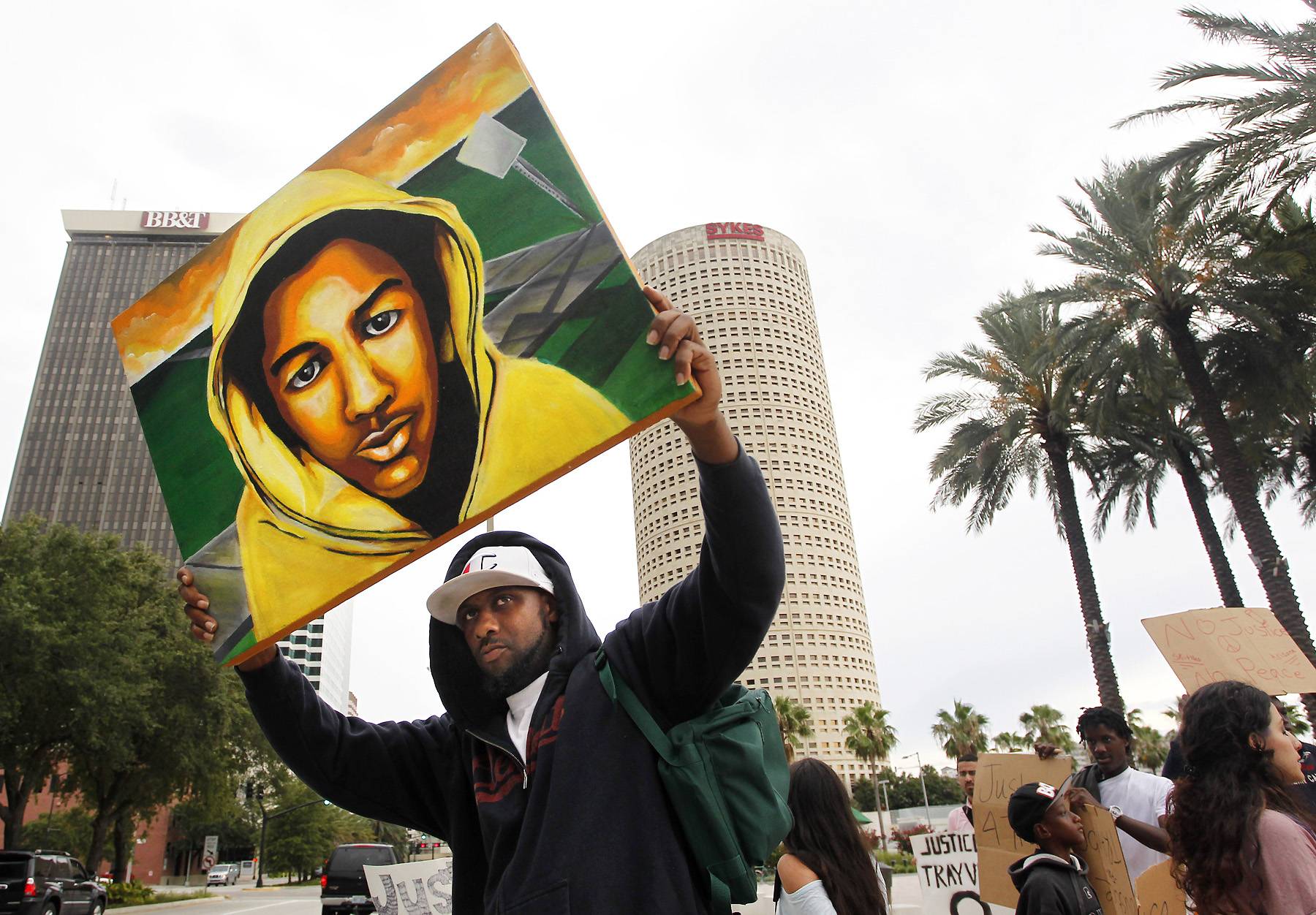 A Portrait of Trayvon - James Brewton, 39, holds up his portrait of Trayvon Martin called &quot;Innocent Eyes, Hard Streets&quot; at a park after marching to the federal courthouse in Tampa, Florida. &quot;I painted it last week,&quot; Brewton said to the Associated Press. &quot;I just had a feeling it wasn't going to go right.&quot; (Photo: AP Photo/Tampa Bay Times, Dirk Shadd)