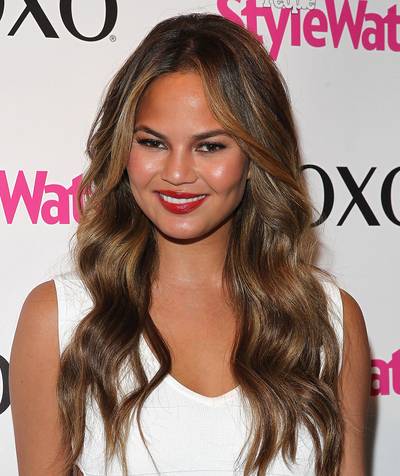 Chrissy Teigen&nbsp; - Chrissy hits the carpet in honey blonde barrel curls, punctuated with a crimson lip and an all-over supermodel glow that you too can achieve! (Photo: Astrid Stawiarz/Getty Images for XOXO)