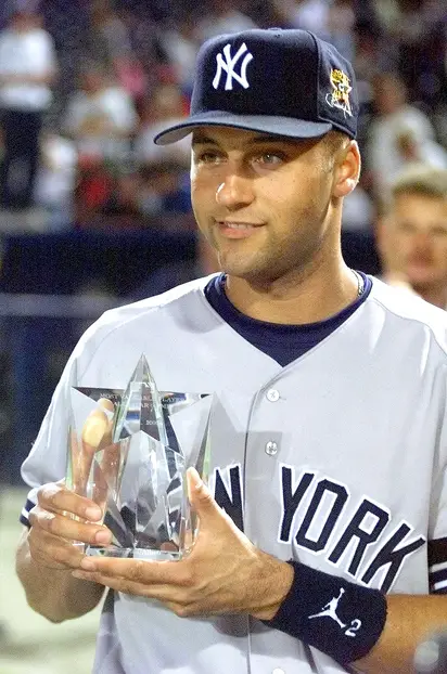 Derek Jeter of the New York Yankees holds up the trophy as he
