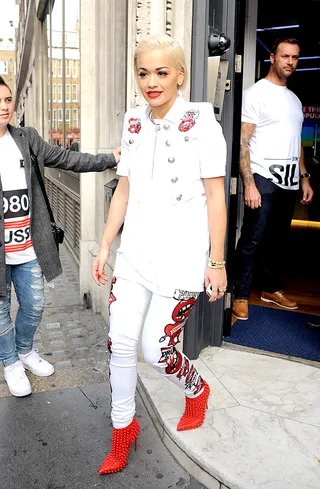 Kiss Kiss - Rita Ora rocks a white denim ensemble with embroidered red lips while hanging out in her hometown of London.(Photo: John McNamara / Splash News)