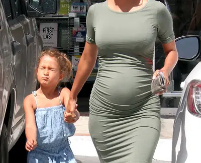 Hello, Baby! - Halle Berry shows off her baby bump in a curve hugging dress as she takes her daughter, Nahla Aubry, to get a passport in Los Angeles. (Photo: FameFlynet, Inc)