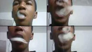 White Smoke Pictured - Trayvon is pictured blowing white smoke from his mouth in this image taken from his cellphone. (Photo: Sanford District Court)