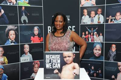 Power in Pictures - Friends visit the Dream Wall and take a peek at the &quot;Because of Them, We Can&quot; coffee table book, which has an adorable boy (Eunique Jones' son) posing as Muhammad Ali on the cover.&nbsp;  (Photo: Vladimir Banjanac for BET)