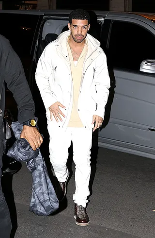 Drake - The rapper takes the sidewalks of Paris in a hooded white parker that will carry the style-conscious gentleman through spring.&nbsp;  (Photo: SIPA/WENN.com)
