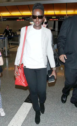 All Eyes on Me - Lupita Nyong'o&nbsp;wades through a swarm of paparazzi at LAX Airport in Los Angeles.&nbsp; (Photo: Splash News)