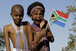 Mvezo Celebration - A child at the Mvezo party holds up a South African flag.(Photo: REUTERS/Siphiwe Sibeko /Landov)