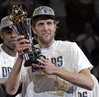 The Man of the Hour - Dirk Nowitzki holds up the MVP trophy. (Photo: AP Photo/David J. Phillip)