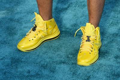 2013: Nelly - Nelly pulled out fresh kicks for the 2013 BET Awards. According to The Post Game, the famous rapper teamed up with Honey Nut Cheerios to create these personalized &quot;Must Be The Honey&quot; LeBron Xs. We especially loved how the bright yellow color of the sneakers beautifully contrasted our custom blue carpet. Perfection!(Photo: Bennett Raglin/BET/Getty Images for BET)