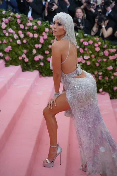 Met Gala Galore&nbsp; - J. Lo was shimmering from head to toe at the 2019 Met Gala in this&nbsp;Versace,&nbsp;v-cut, crystal dress with a head piece to match!&nbsp;(Photo: Sean Zanni/Patrick McMullan via Getty Images)