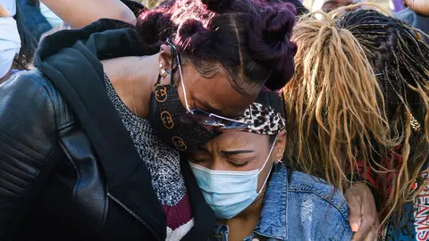 Ex-wife Tashera Simmons (L) and fiancee Desiree Lindstrom (R) hug while surrounded by friends of hospitalized rapper Earl Simmons, aka DMX, attend a prayer vigil hosted by the Ruff Ryders to the Rescue Foundation at White Plains Hospital on April 5, 2021 in White Plains, New York. - Gritty US rapper DMX was hospitalized and on life support on April 3 after a heart attack, his lawyer Murray Richman told AFP. 
"He was hospitalized at 11 o'clock last night at the hospital in White Plains," the New York suburb where he lives, after suffering "a heart attack," Richman, who has represented the rapper for 25 years, told AFP. (Photo by Angela Weiss / AFP) (Photo by ANGELA WEISS/AFP via Getty Images)