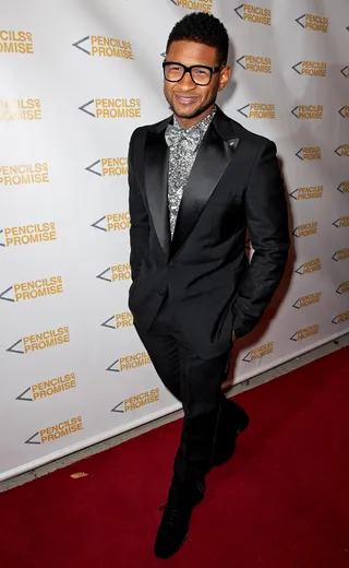Glimmer of Hope - Usher in a perfectly tailored suit adds a little shine on the red carpet with a shimmering silver bow tie and shirt at the Pencils of Promise 2011 charity gala at Espace in New York City. (Photo: D Dipasupil/Getty Images)