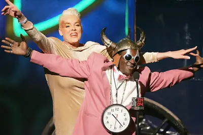 Flavor Flav (2004) - A man who wears a clock that's bigger than his head is never afraid of making a statement. Here, Flavor Flav poses with Brigitte Nielsen at the VH1 Big in '04 event while rocking a rose colored blazer.(Photo: Kevin Winter/Getty Images)