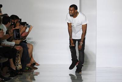 Take a Bow!&nbsp; - After the show, Kanye took a bow amid applause for the showing of his first fashion collection. The designer kept it simple in a white T-shirt, black jeans and Nike sneakers. Maybe he’ll foray into menswear next?(Photo by Pascal Le Segretain/Getty Images)&nbsp;