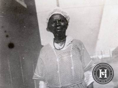 The Face of Hope - Many of the Greenwood District's residents were only a generation or two from enslavement. They had come to the area having left other places in the South seeking better opportunities. The oil industry attraced Black investors, who in turn sold land to Black entrepreneurs, who build what came to be known as &quot;Black Wall Street.&quot; Here a Black woman is photographed near the Booker T. Washington High School.