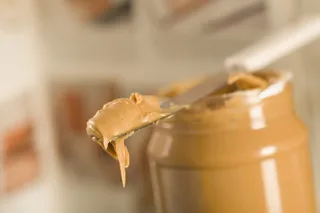 Peanut Butter Protein - A spoonful of peanut butter before heading out on that run will have you charged up and ready to pound the pavement.Close-up of peanut butter --- (Photo: Glowimages/Corbis)